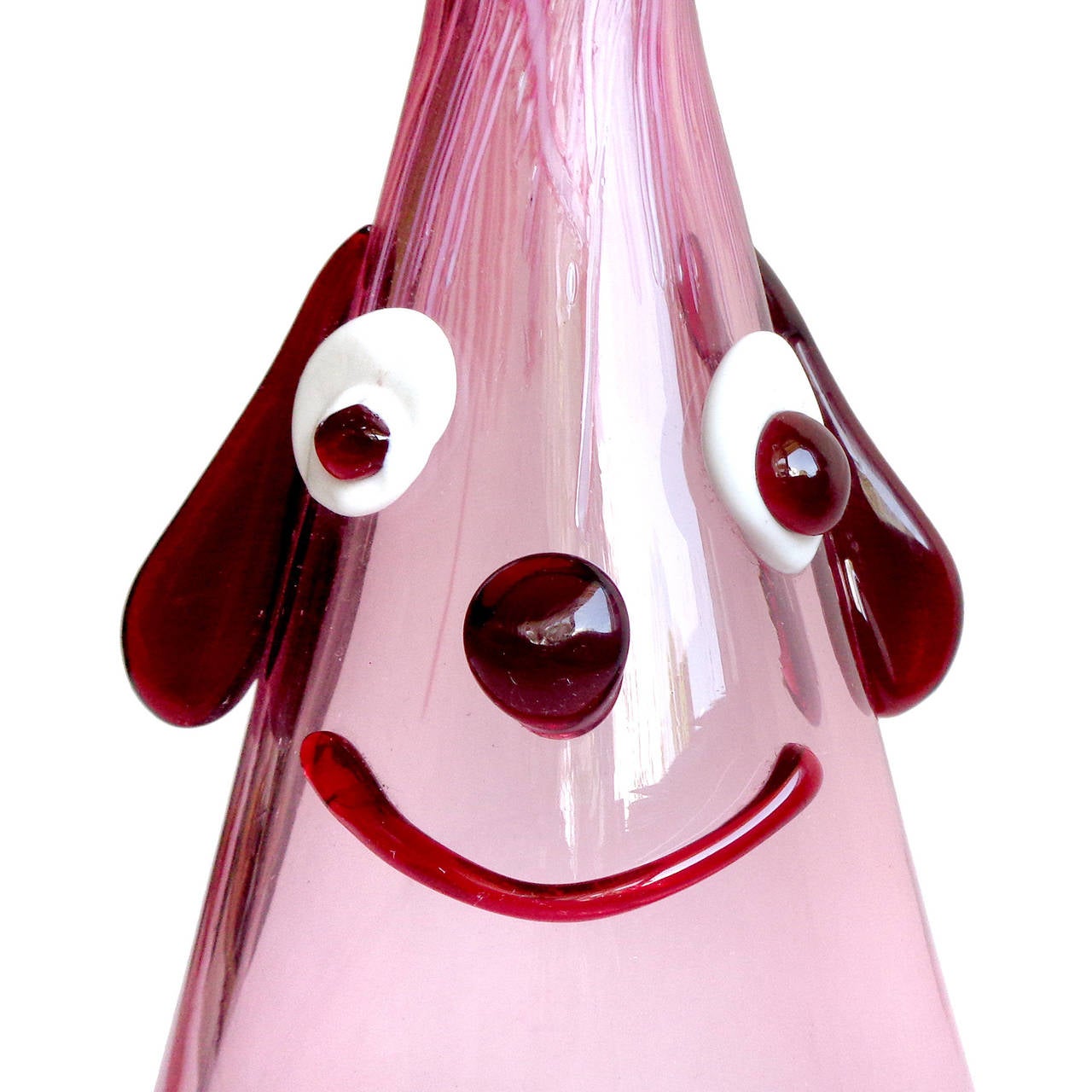 Free shipping worldwide! See details below description.

Cute and unusual Murano handblown cranberry pink, with applied red and white clown face. Documented to the Fratelli Toso Company. The piece has droopy ears, wide eyes, a big smile and