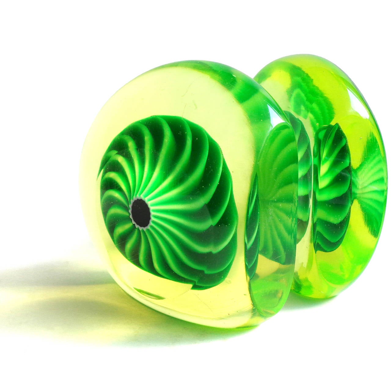 Free shipping worldwide! See details below description.

Amazing set of Murano handblown, vaseline/uranium glass and large swirling murrines art glass bookend sculptures. Documented to designer Galliano Ferro. The pieces glow incredibly bright