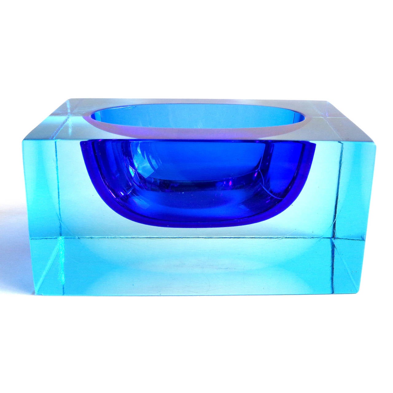 Free shipping worldwide! See details below description.

Amazing vintage Murano hand blown Sommerso cobalt and light blue rectangular art glass bowl. The piece is a solid glass block with a half submerged orb in the center. Super heavy and thick.