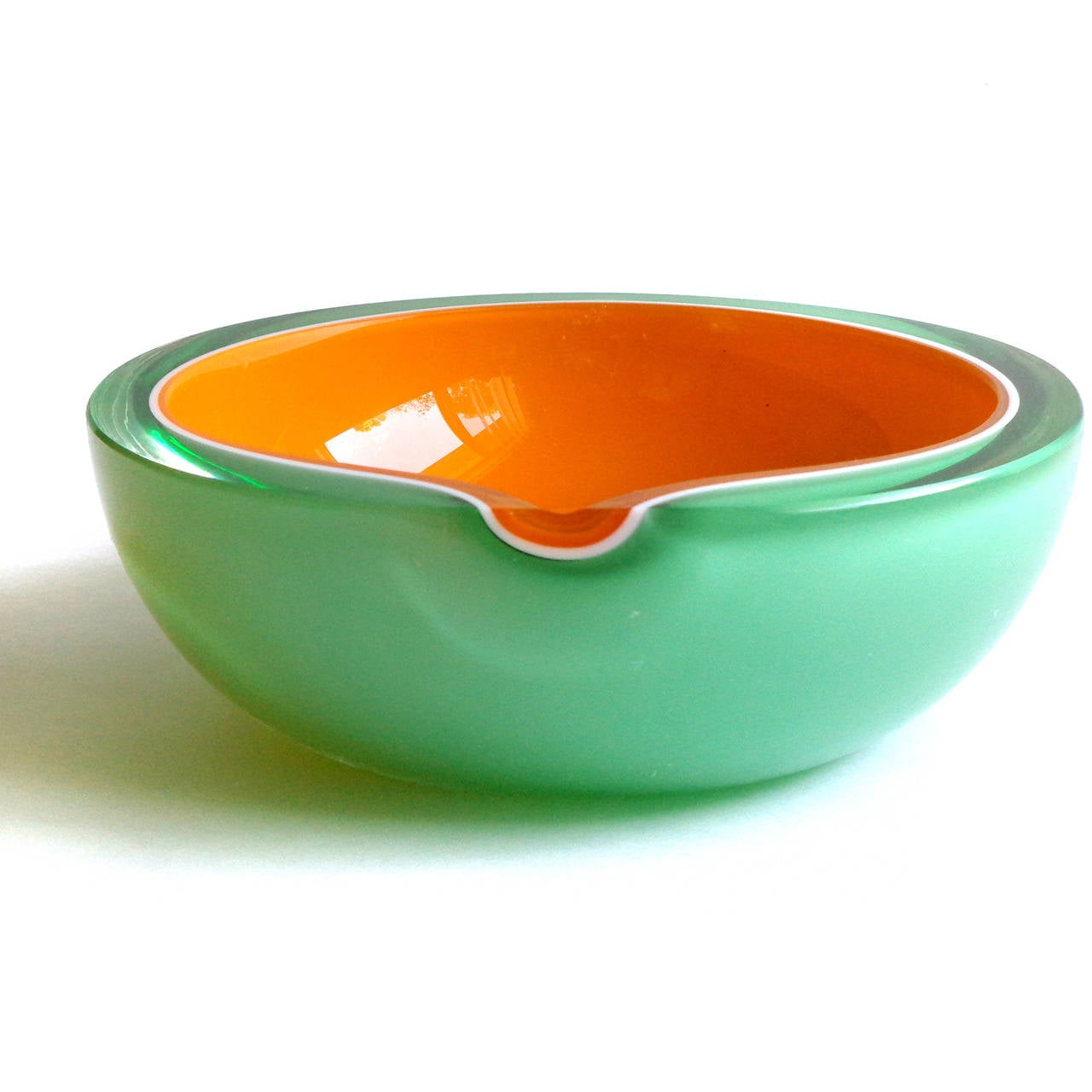 Beautiful Murano hand blown bright orange, green and white art glass melon shaped bowl. Documented to the Fratelli Toso company. The piece has a flat rim, with a flat cut side (on purpose). It is made with 4 layers of glass. Gorgeous color and