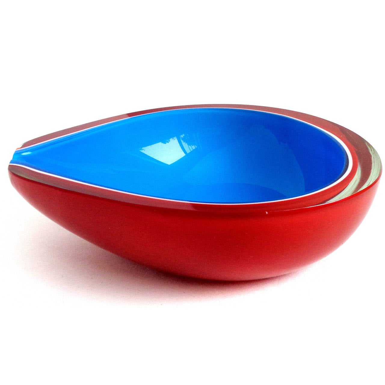 Beautiful Murano hand blown bright red, white and blue Italian art glass half pear shaped bowl. Documented to the Fratelli Toso company. The piece has a flat rim, with a flat cut side (on purpose). It is made with four layers of glass. Has remnants