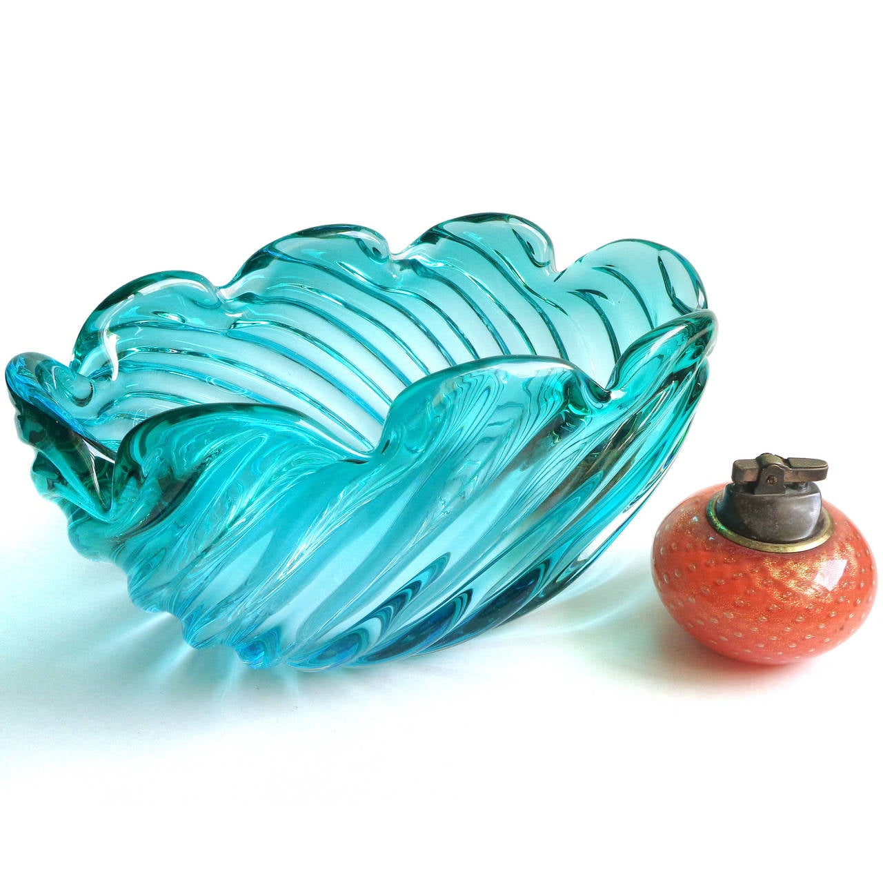 Free shipping worldwide! See details below description.

Beautiful large Murano handblown aqua blue green Sommerso art glass center bowl. Documented to designer Alfredo Barbini. The bowl has a subtle fade in color. In the folds a richer blue and