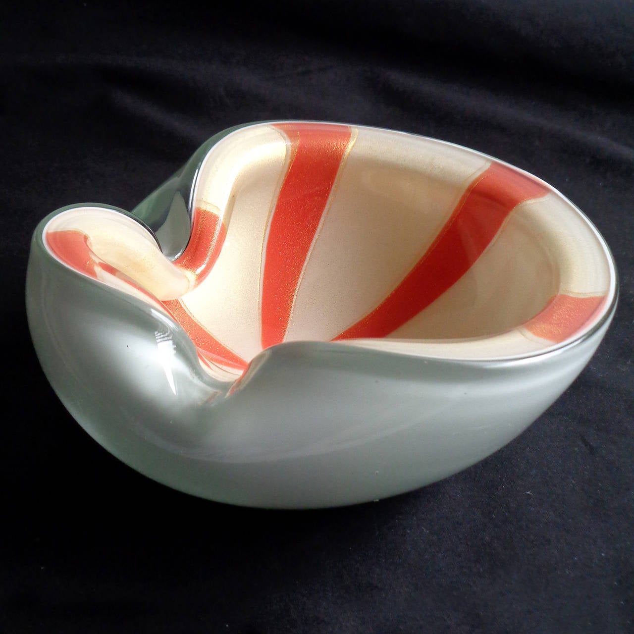 Free shipping worldwide! See details below description.

Beautiful Murano handblown orange stripes, white and gold flecks art glass bowl. Documented to designer Alfredo Barbini. The piece has bright orange stripes, and filled with gold leaf on the