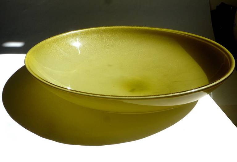 Free shipping worldwide! See details below description.

Very Large Murano Hand Blown Yellow - Olive Green with Gold Flecks Art Glass Centerpiece Bowl. Attributed to designer Alfredo Barbini, circa 1950s. It is profusely covered in gold leaf on