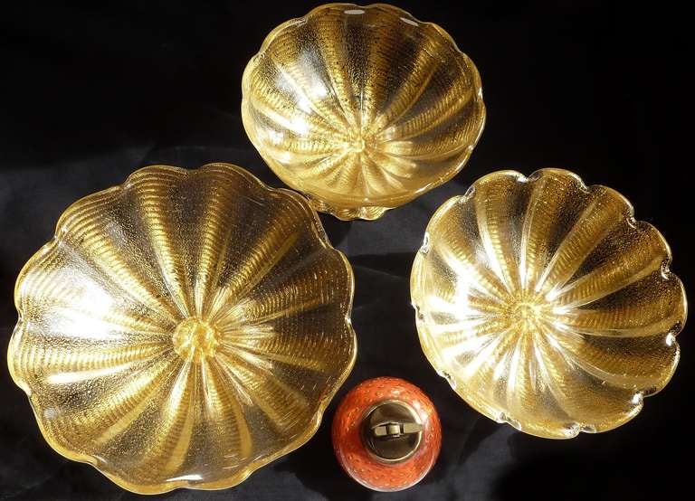 Incredible Murano Hand Blown Gold Flecks Art Glass Footed Centerpiece Bowls. Created by Ercole Barovier, for Barovier e Toso in the Cordonato D’ Oro design. They vary in size, each a little larger than the next.
The 3 pieces are being sold here as