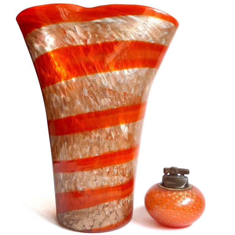 Free shipping worldwide! See details below description.

Large Murano handblown red orange candy stripe ribbon and aventurine flecks art glass vase. Documented to the Fratelli Toso company, circa 1950s. The piece has a pinched rim, profusely