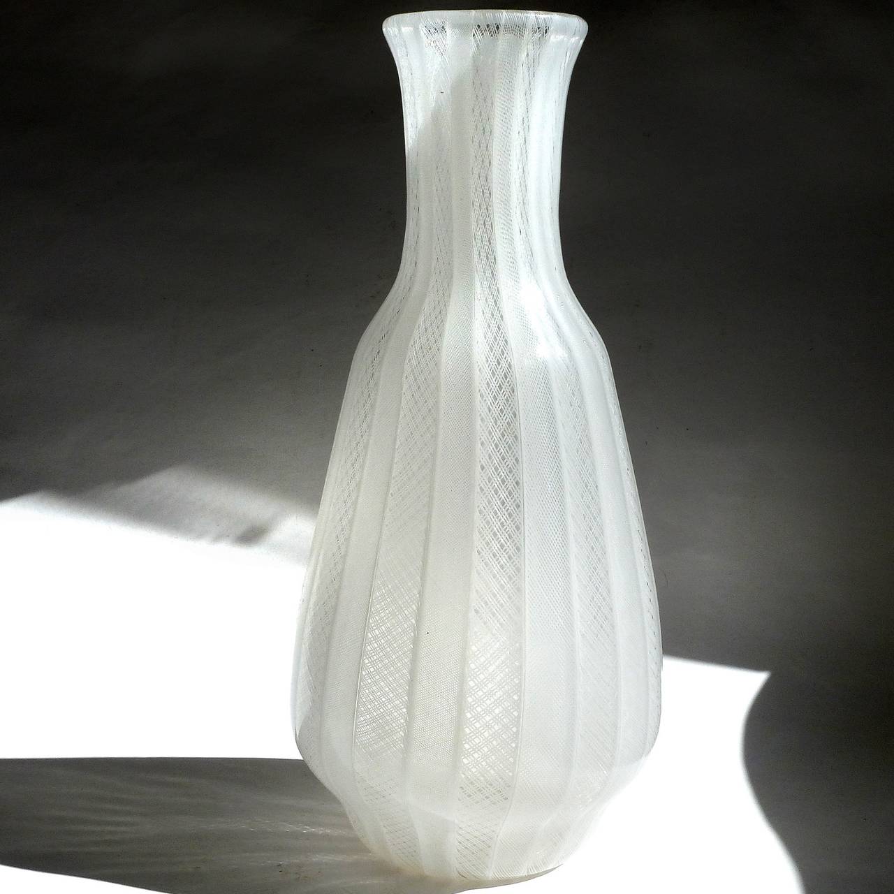 FREE Shipping Worldwide! See details below description.

Gorgeous and large Murano handblown pure white art glass zanfirico ribbons flower vase. Created in the manner of the Venini and Salviati companies. It has 2 different lace net designs that