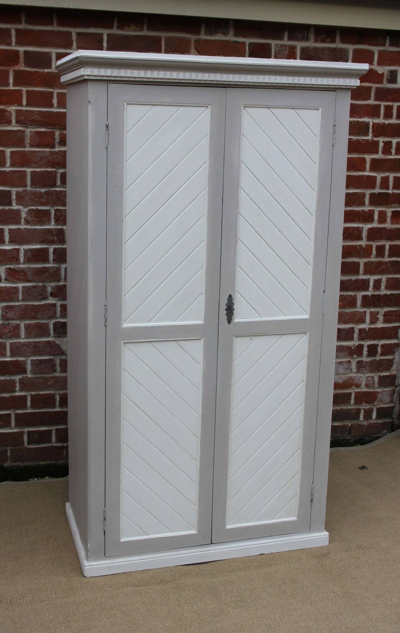 Painted wardrobe having two panelled doors and a moudled top.Can be fitted with a hanging rail or shelves
