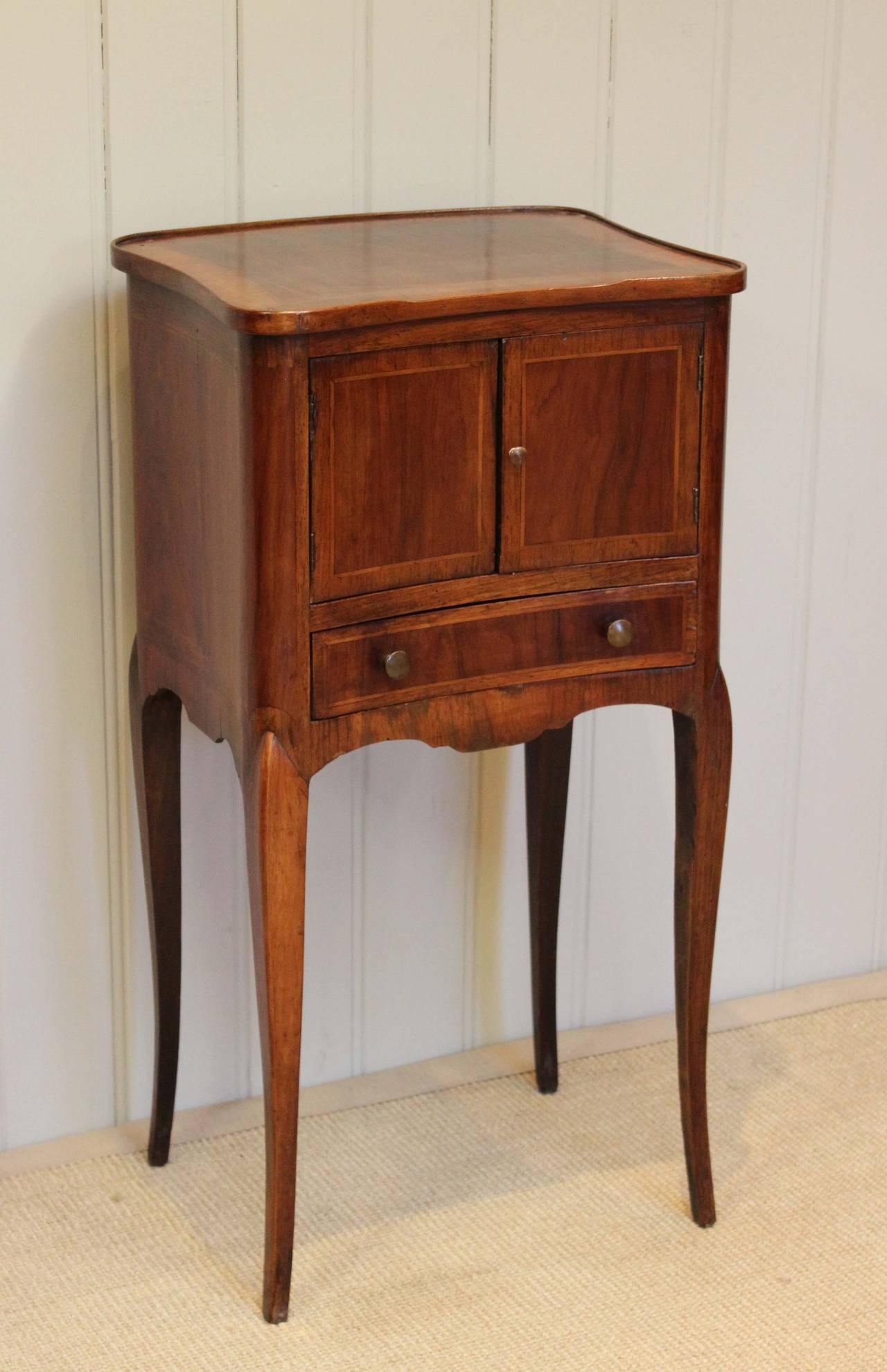 French bow front inlaid rosewood two door, single drawer nightstand raised on straight tapering legs