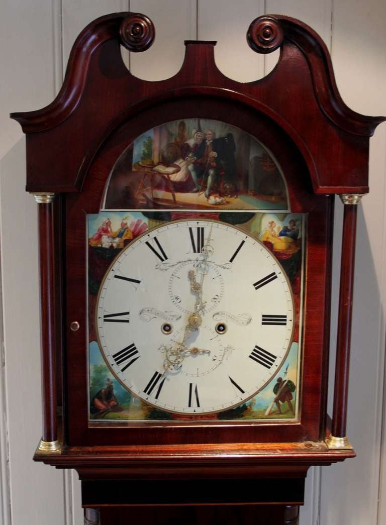 A fine early 19th Century original longcase clock. It has a deep figure mahogany case, typical of many Scottish clocks. The hood has a swan neck pediment and side columns with brass capitals. The trunk has a long arch top door with side columns and