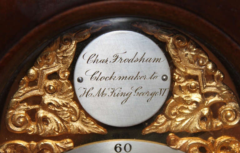A small late 18th Century style bracket clock, having a mahogany case, with a break arch top and gilt brass handle.The brass dial has a silvered chapter ring and name plaque, a matted brass centre and gilt spanrels. The 8 day movement has a lever