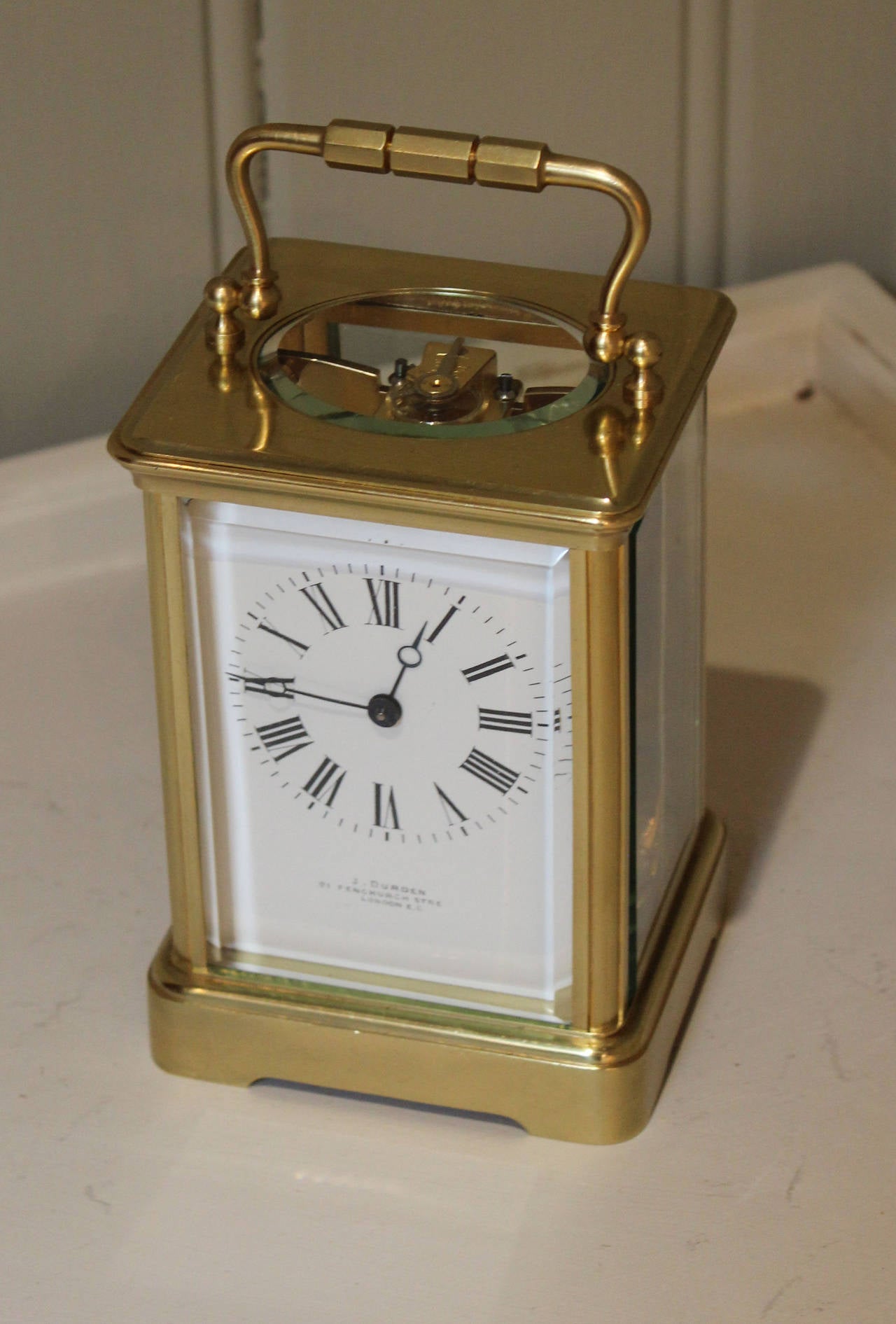 A large, mid 19th Century French carriage clock. It has a corniche case, with a large oval bevel edge top window and thick beel side glasses. The enamel dial is signed by the original retailer, J Durden, Fenchurch Street, London. (Worked 1869-188).