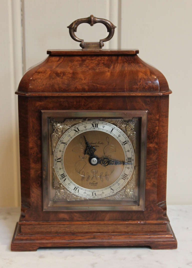 A small 18th Century style bracket clock, in a burr walnut case. It has a brass carrying handle, a square dial with a silvered chapter ring and is signed by the original retailer Shortland of Brighton. It has an 8 day timepiece(does not strike)
