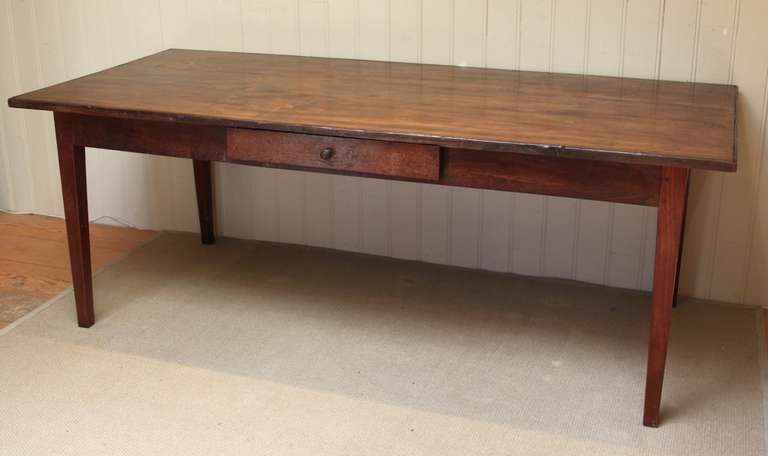 A 19th Century French farmhouse table, having a solid poplar top, with a beaded edging, standing on its original oak and poplar pegged jointed base, with a single frieze cutlery drawer. (seating clearance under rail is 60.5cm.)