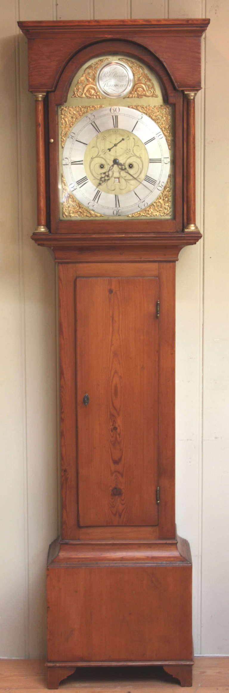 An original late 18th Century Scottish longcase clock. It has a flat top hood with a break arch door and side windows, a long door and bracket a feet base. The break arch brass dial has fine engraving with a silvered chapter ring and a name plate
