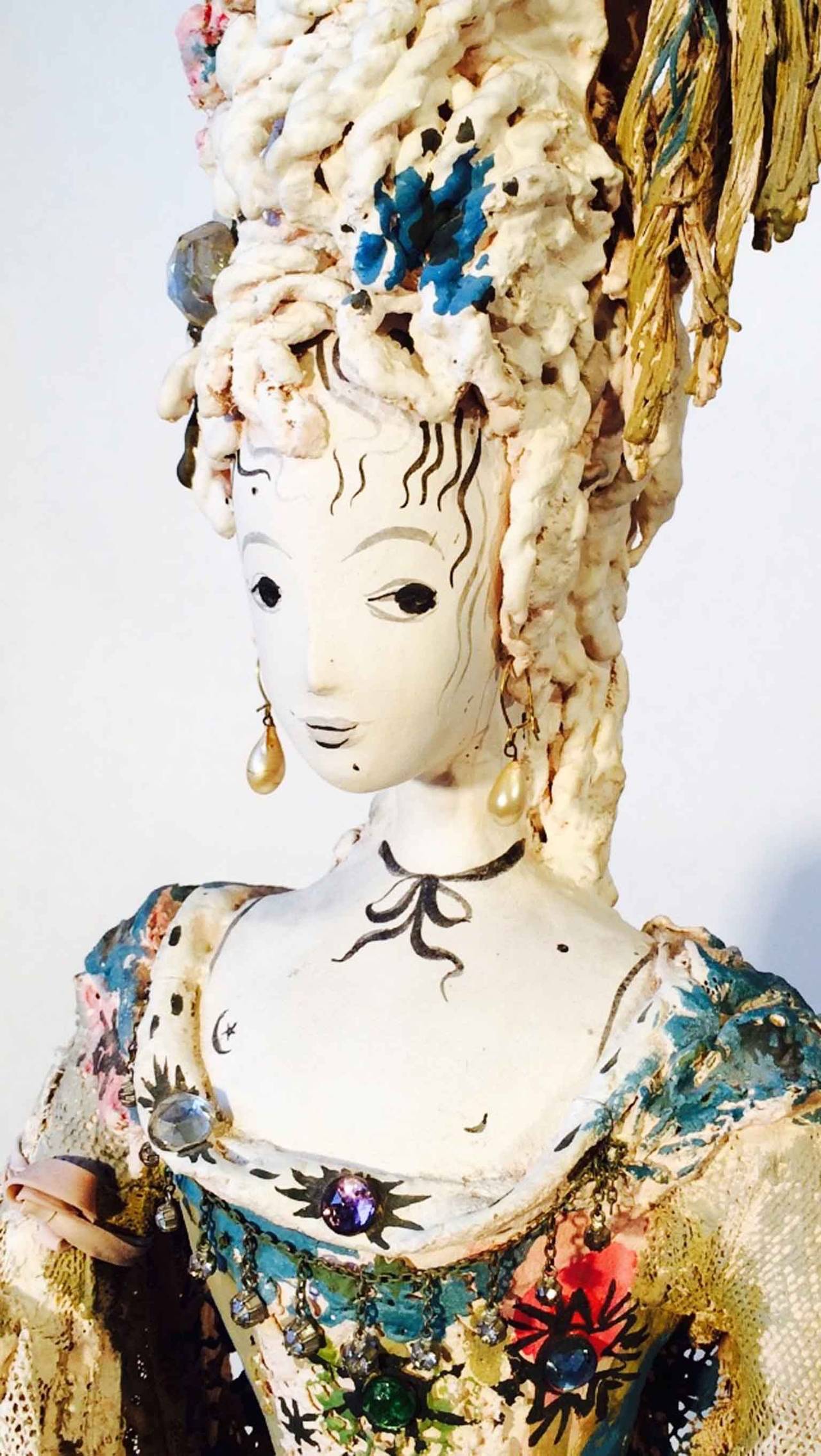 An exquisite pair Tony Duquette mated fantasy figural sculptures. Unsigned hand constructed and painted plaster, papier mâché, lace, wood, found items, crystal etc. Fantastic Hollywood Regency period design and execution, 1940s. Female figure