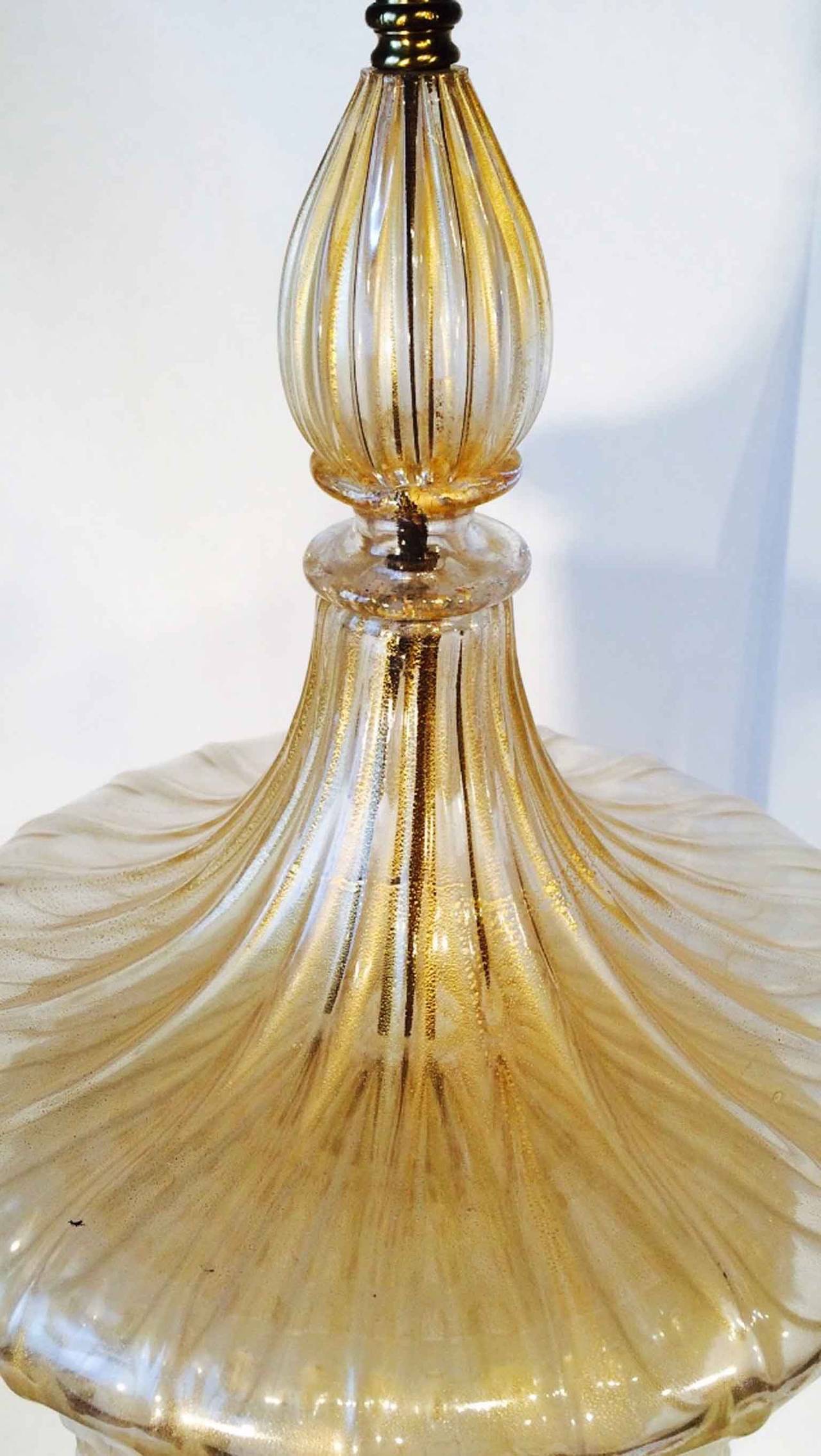 Stunning and rare pair of Barovier e Toso Murano glass lantern table lamps. Impressively large handblown glass items in clear with internal metallic gold dust. Six matched segmented glass elements mounted on a giltwood bases with polished brass