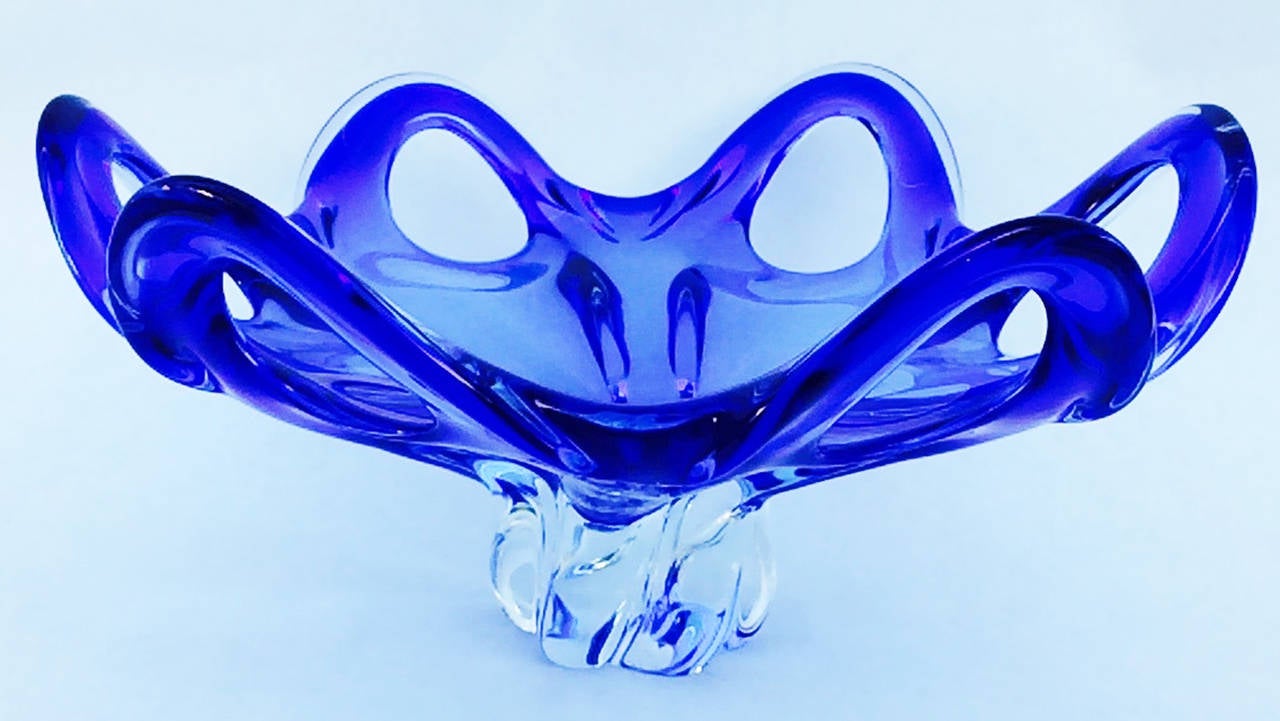 A finely executed Mid-Century Modern Murano glass bowl. Unsigned cased vivid blue and clear glass item forms a impressive six-handled bowl. Impressive example with no issues.