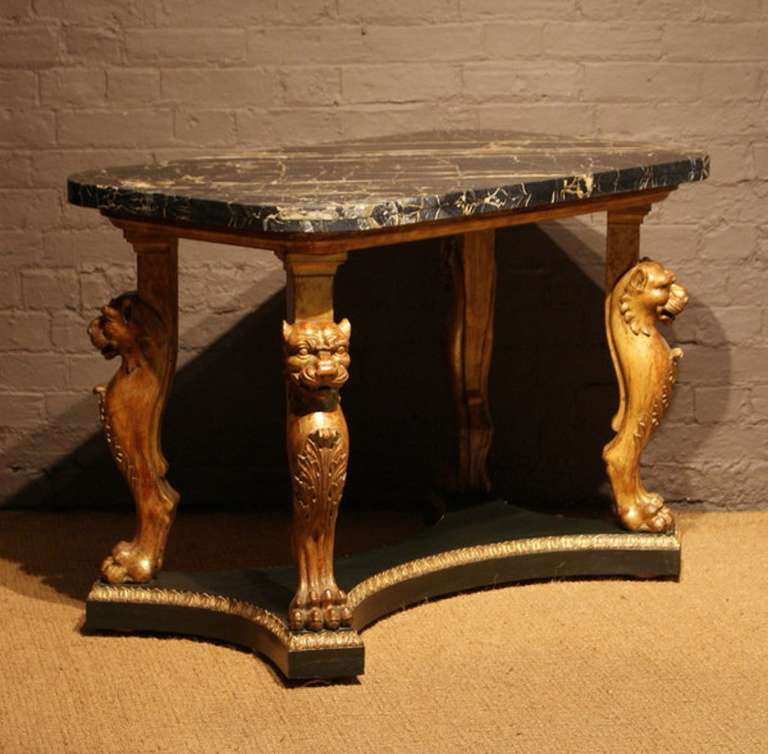 A Regency period carved giltwood and bronzed centre table, with archeological Romanesque panther monopodia.

In the manner of Thomas Hope, after the Vatican sketches of C. H. Tatham.

Charles Heathcote Tatham (1772-1842), arrived in Rome in July