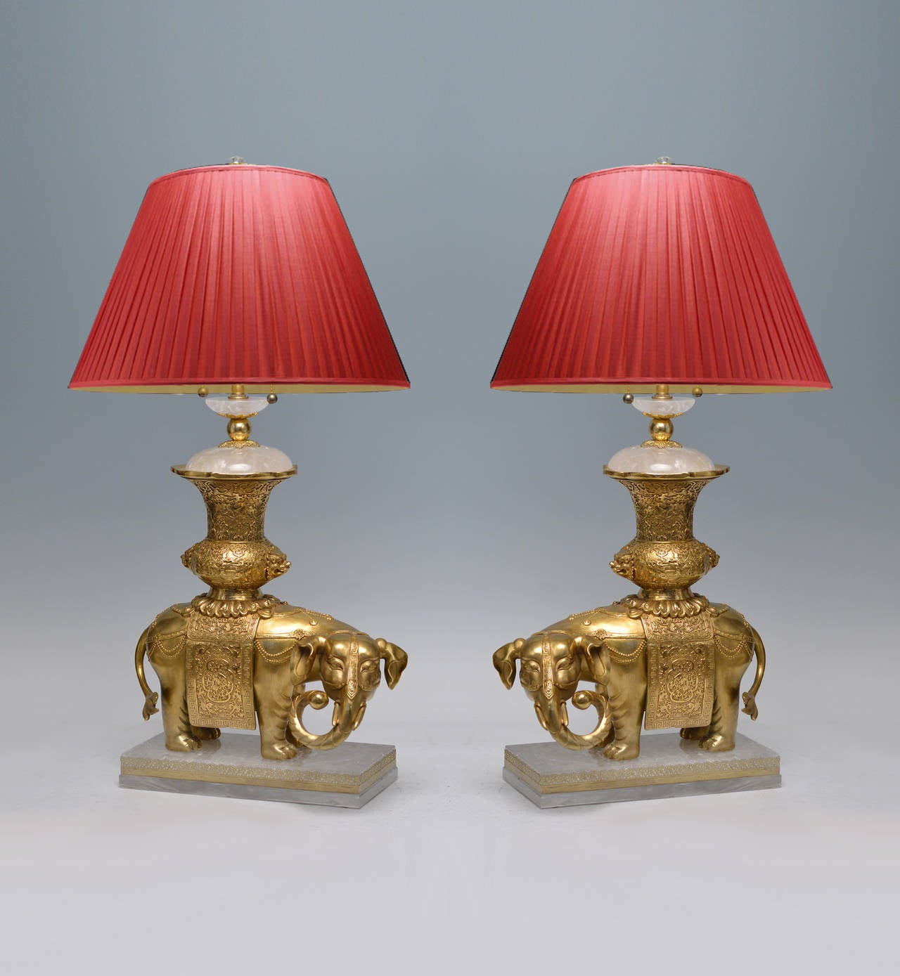 Fine cast gilt bronze figures of the elephant's lamps with rock crystals.