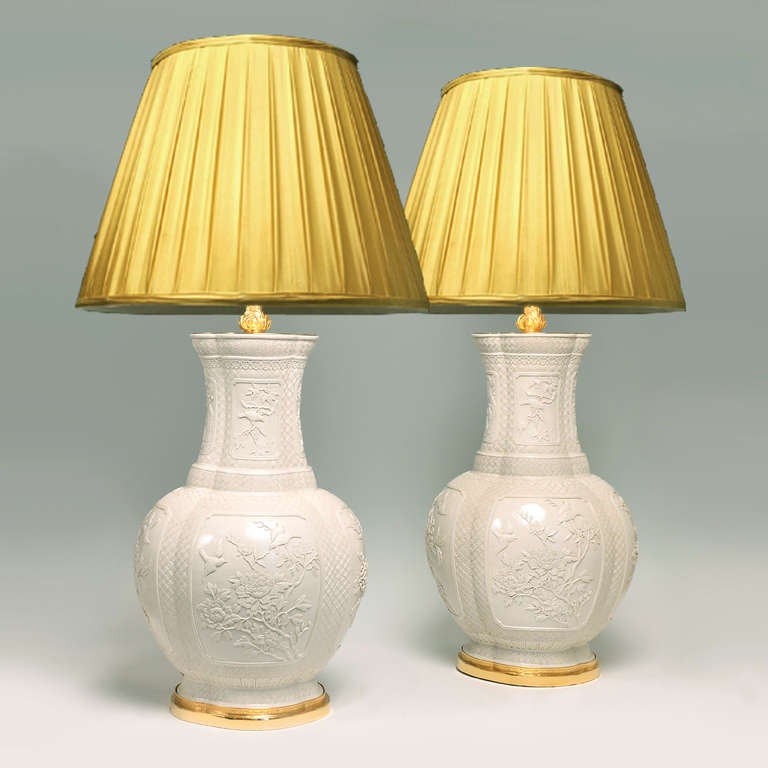 Fine carved Blanc De Chine porcelain vases mounted as lamps, with floral blossom and birds decorations,ca1930