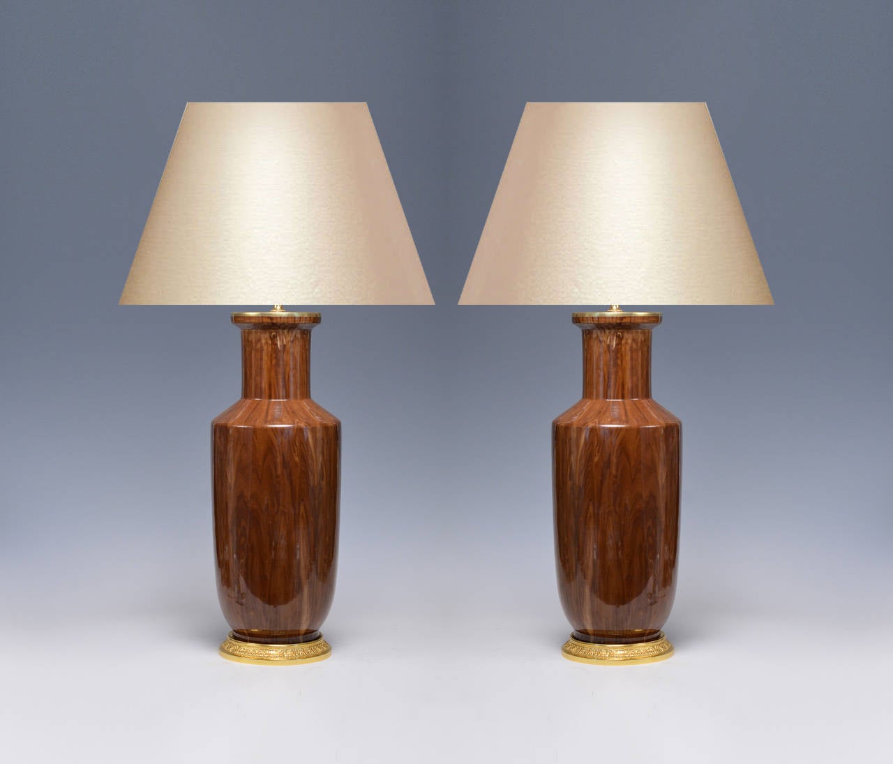 Pair of fine painted wood grain porcelain lamps with gilt brass bases. Measure: 19 3/4