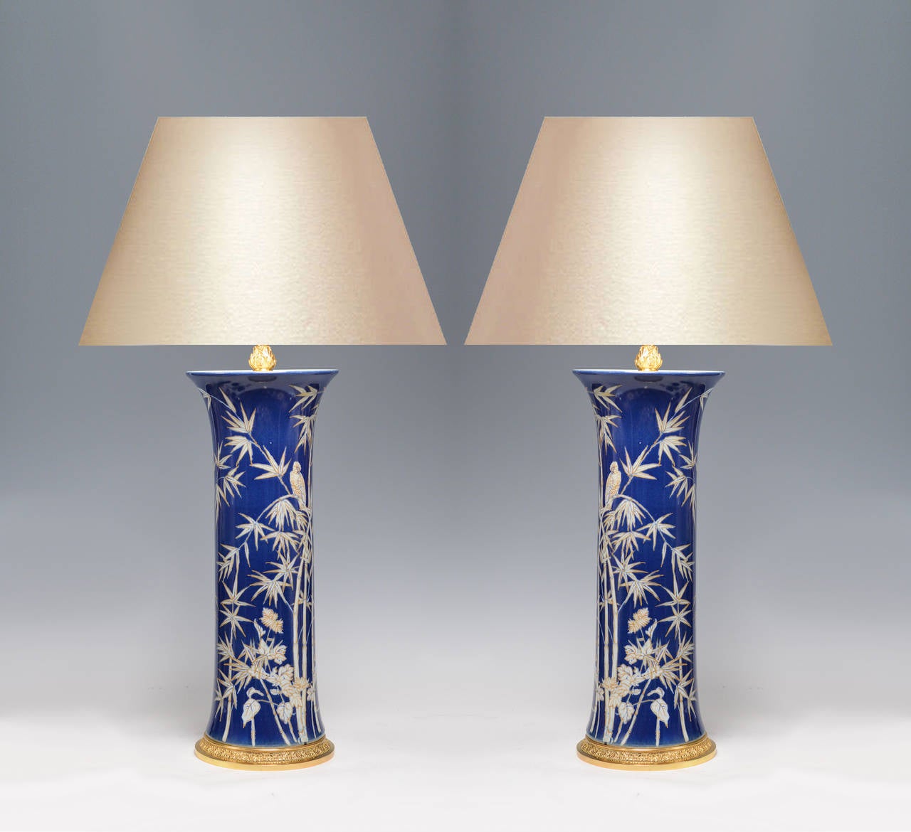 Pair of fine painted blue and white porcelain lamps with bamboo and bird decoration, gilt bases. 21