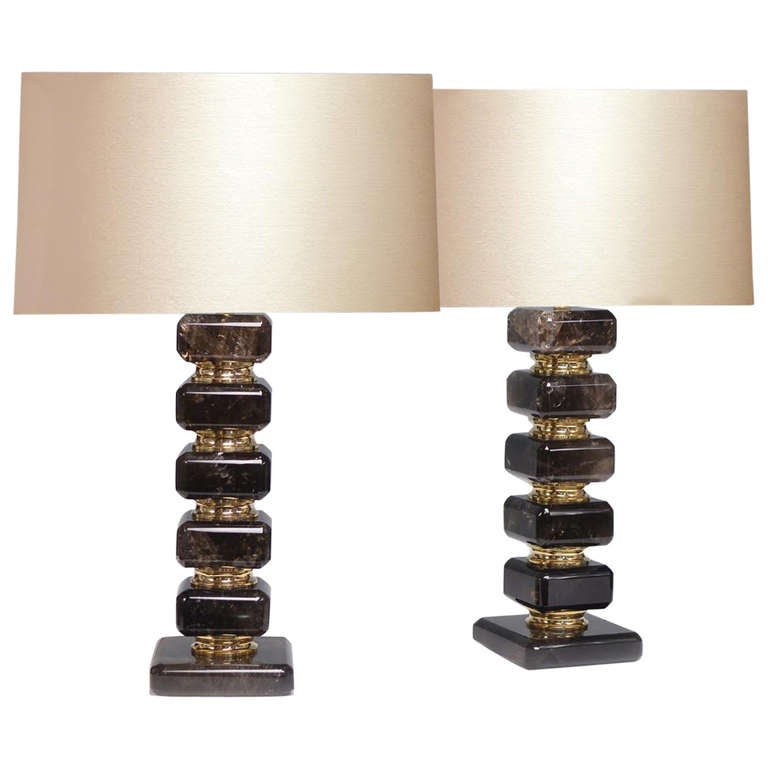 A fine carved cubic form smoky brown rock crystal quartz lamp with polish brass decoration, created by Phoenix Gallery, NYC.
Available in nickel plating and antique brass finished.
Measure: To the rock crystal: 14.125