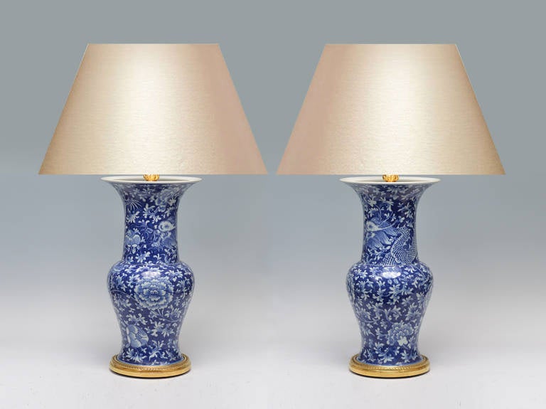 Fine painted blue and white porcelain vases with dragon, phoenix and flower blossom decoration, gilt bronze base, CA 1970