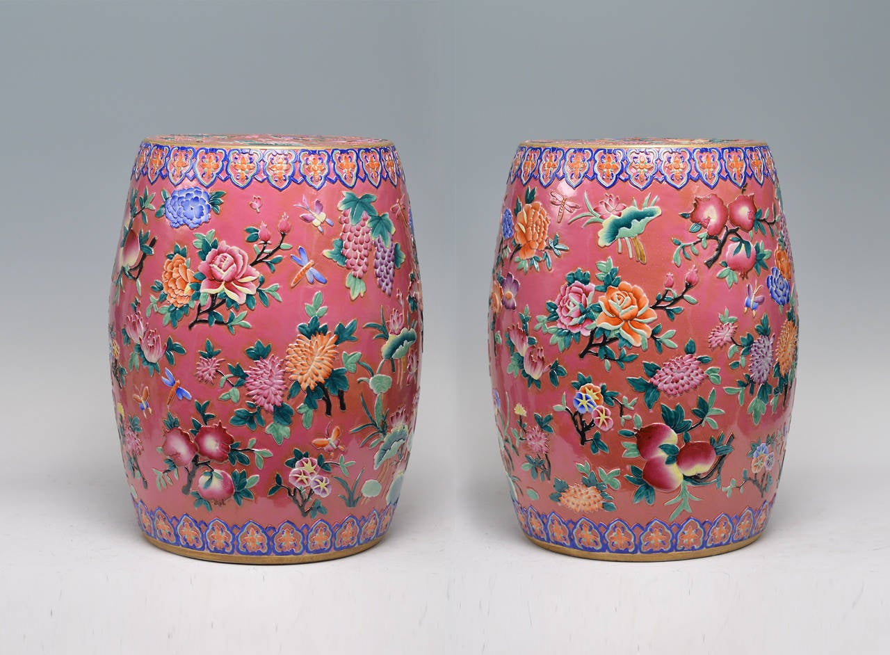 Pink-ground porcelain stools with finely carved low relief flower blossom decoration.