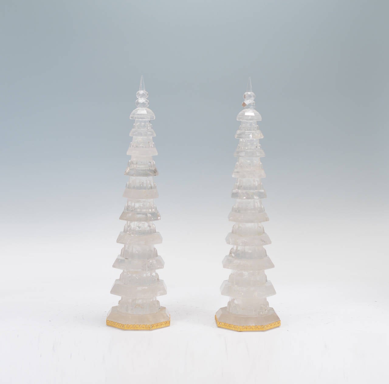 Pair of fine carved rock crystal pagodas rising from the gilt embellished bases, with delicate details on each octagonal storey, and double gourd finials.