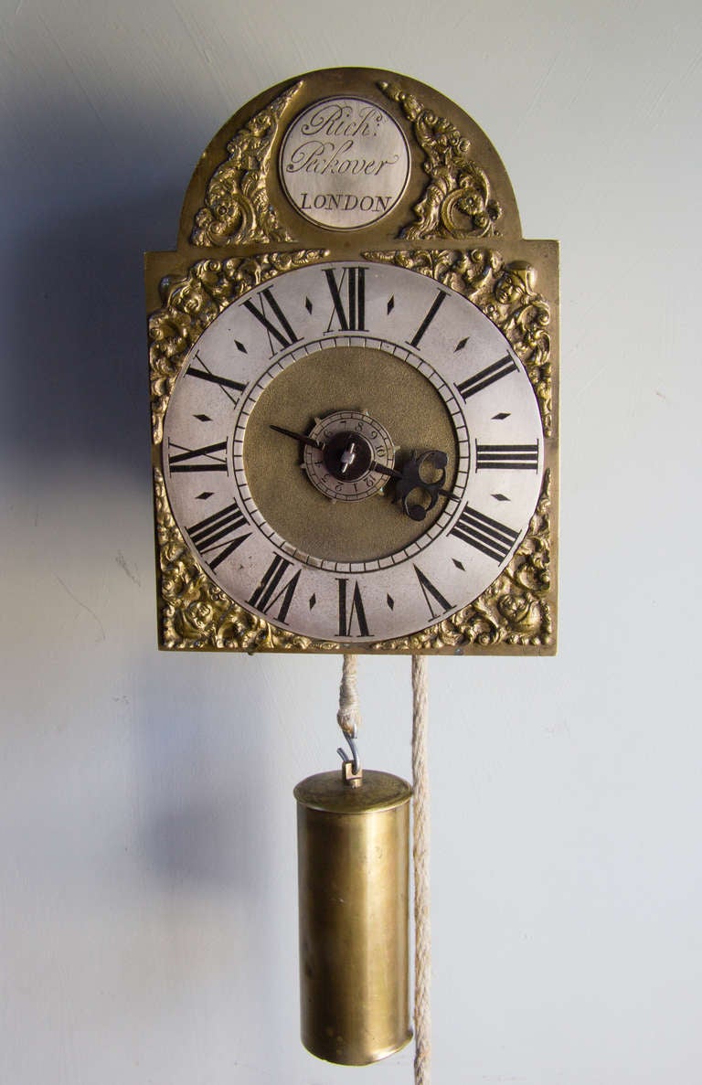 The 30 hour movement is of a typical lantern clock construction with four cast brass pillars with top and bottom plates which support the vertical movement plates, these and thus the wheels are held in place by dovetail wedges. A hole in the