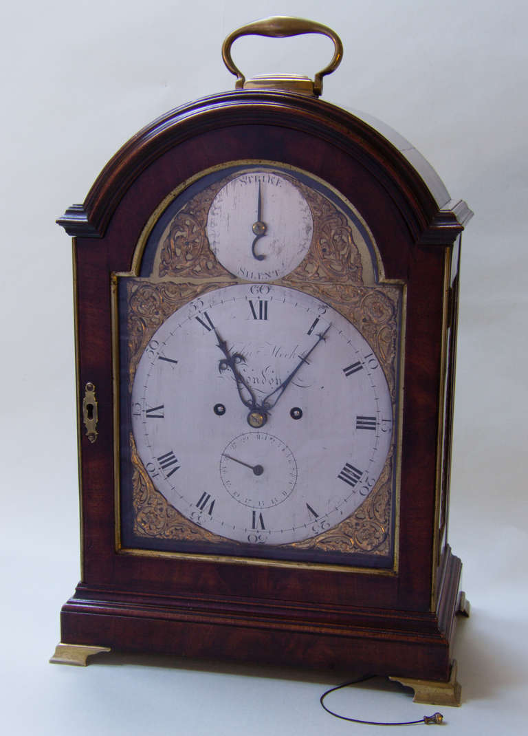 Eight day verge bracket clock with original escapement. The backplate is fully engraved with floral swags and festoons which are clearly visible through a glazed backdoor complete with undulating character glass. Following the lines of the top of