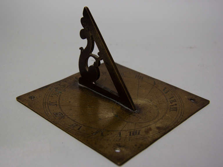 Brass engraved sundial with the original gnomon. The angle of the gnomon is approximately 51.5 degrees, the latitude of London.  The hour chapters are divided into 1/2s, 1/4s as on an early single handed 30 hour dial but it is also divided into 1/8s