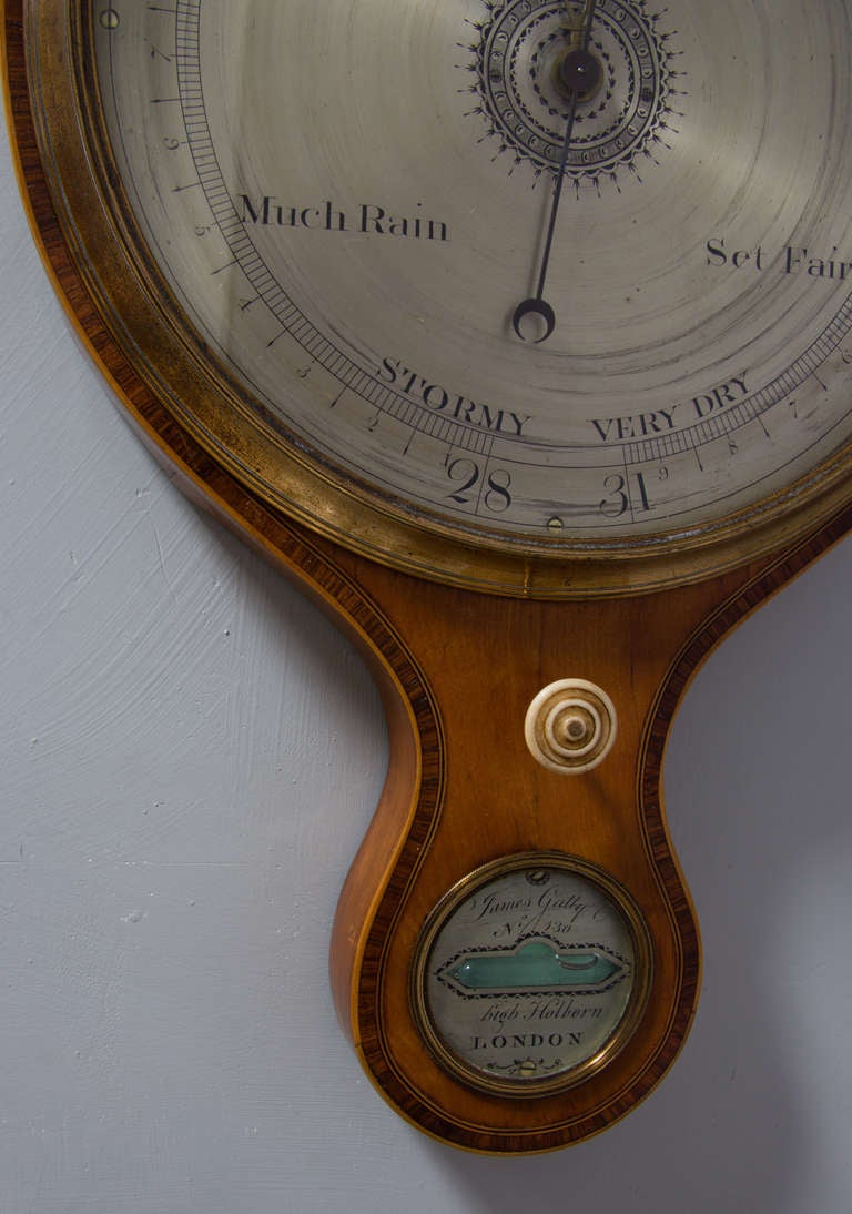English Satinwood wheel barometer signed James Gatty. London.