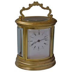 Oval French carriage clock signed Drocourt, No. 9790.