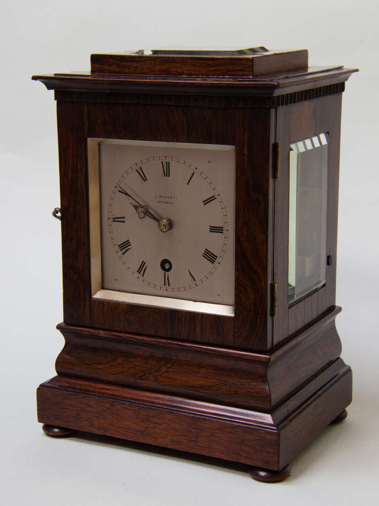 Small rosewood library clock signed J Bennett, Norwich. 
Single train fusee movement with a chain drive. The movement is held in place with two right-angled brackets and the pendulum is fitted with a locking bridge and knurled screw, which enables