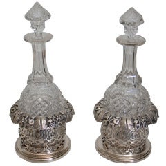 Pair of Pierced and Floral Silver Plated Wine Coasters and Decanters