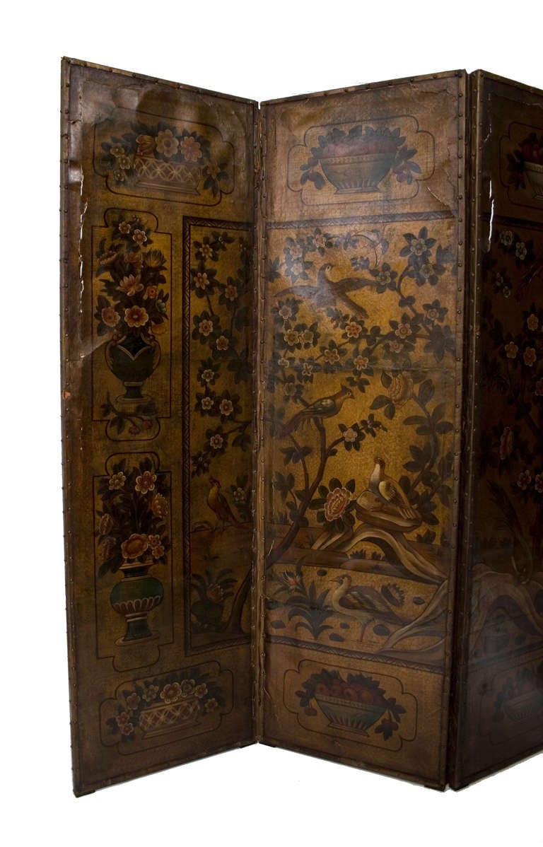 A Dutch embossed and gilded leather polychrome painted 4-panel screen decorated with a landscape of flowering trees and birds in the Chinese taste.