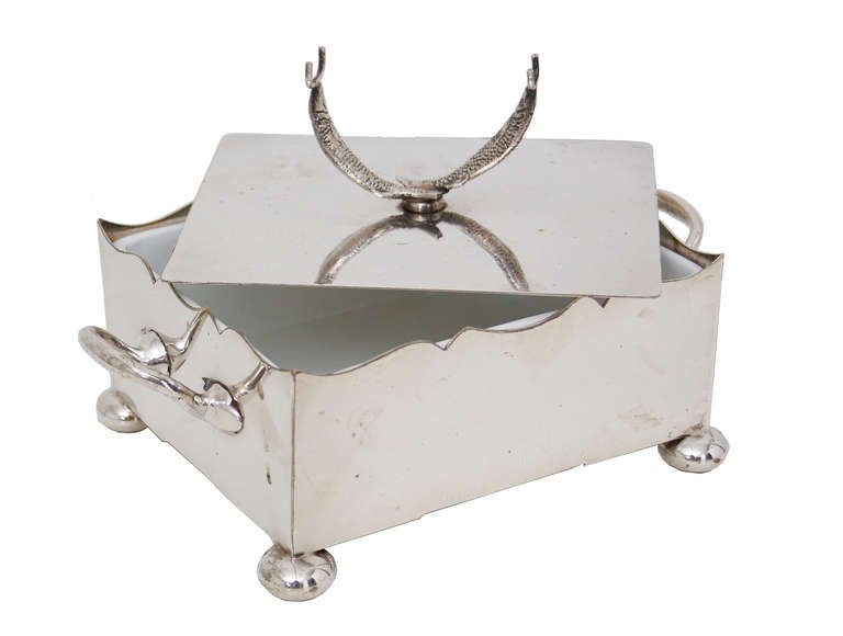 Silver plate sardine dish with glass liner, the lid with sardine-form handle and with a shaped rim, twin handles and ball feet.