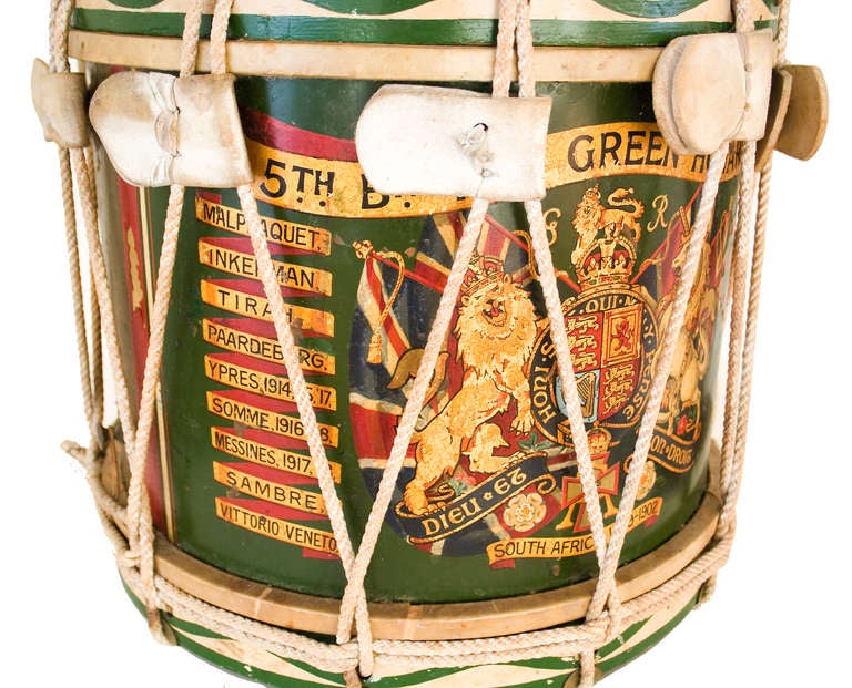 An English Regimental drum, dark green with gilt and polychrome decoration.