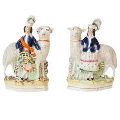 Antique A pair of Staffordshire pottery figures.