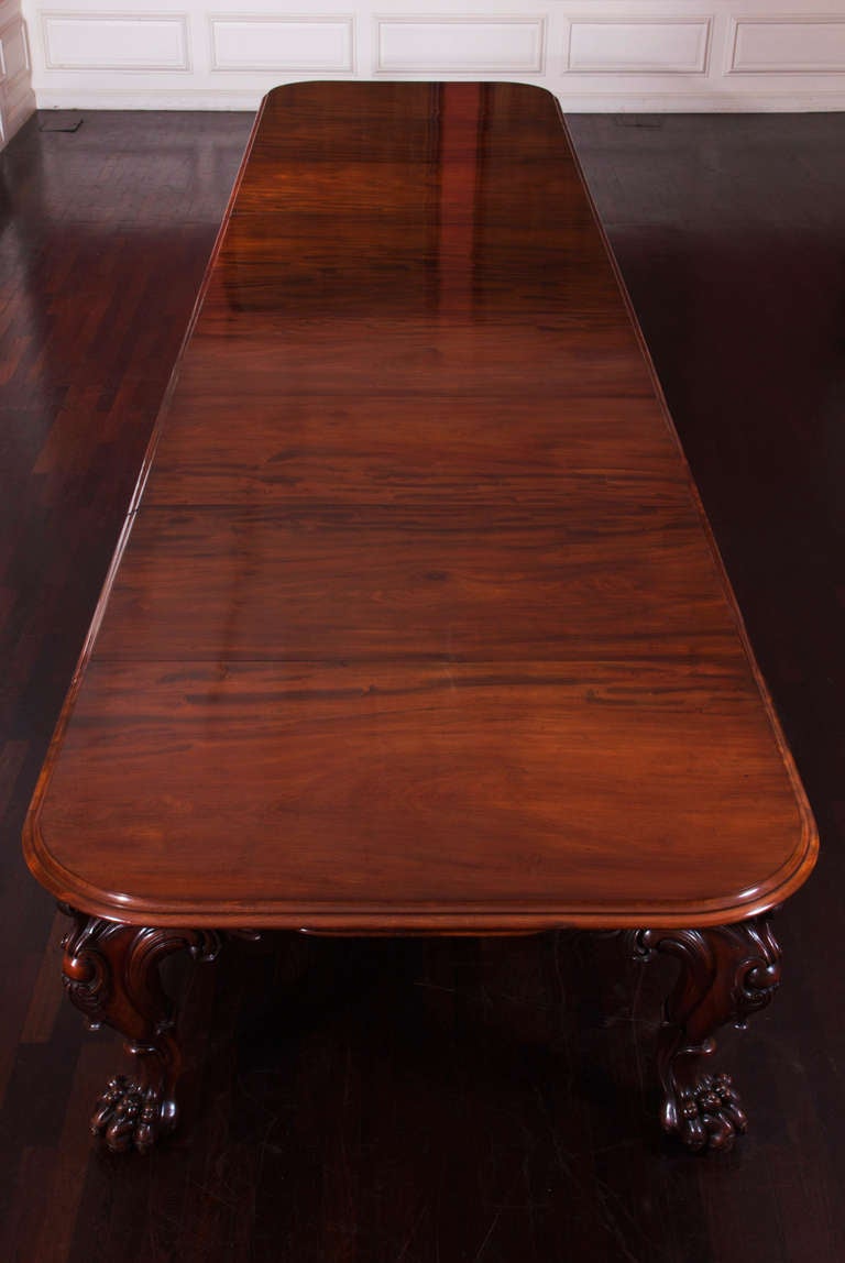An exceptionally large mahogany dining table, the Cuban mahogany of remarkable quality with superb figuring and outstanding colour. Unusually the entire table is constructed of the very best mahogany, including the under-bearers. The rectangular top