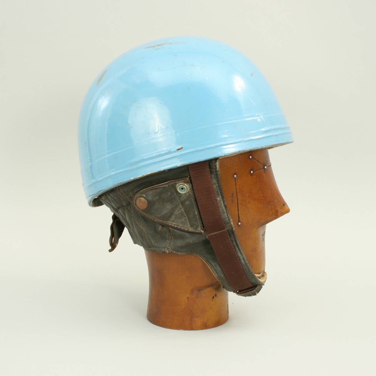 Vintage Cromwell motorcycle crash helmet.
A fine blue painted motorcycle, pudding basin shape helmet made in England by Cromwell. This helmet has a cork interior, fitted with a felt headband and straps keeping a space between the head and outer