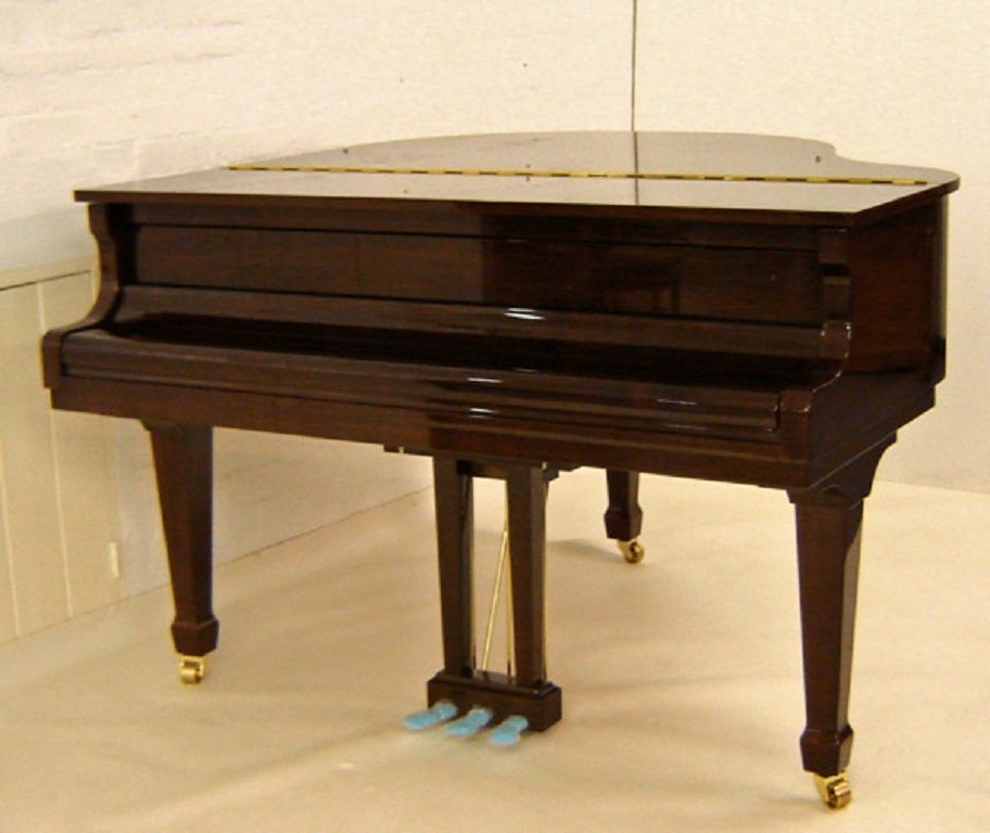 Bentley 148cm baby grand piano in dark walnut polish New - due in Mid March 2015 (Similar to picture) 
(also available in stock in black polished - ask for details) 

Full compass - 71⁄4 octaves – 88 notes 
3 pedals (sostenuto pedal)