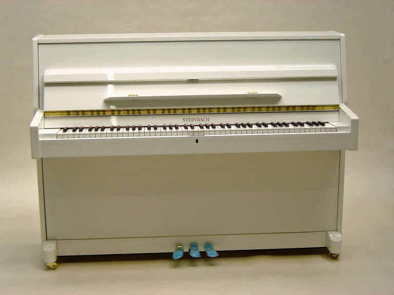 Steinbach 108cm modern upright piano white polished new 
(Similar to picture but gliders instead of wheels) 

Full compass - 7¼ octaves – 88 notes 

White polished - not available on our home rental scheme.