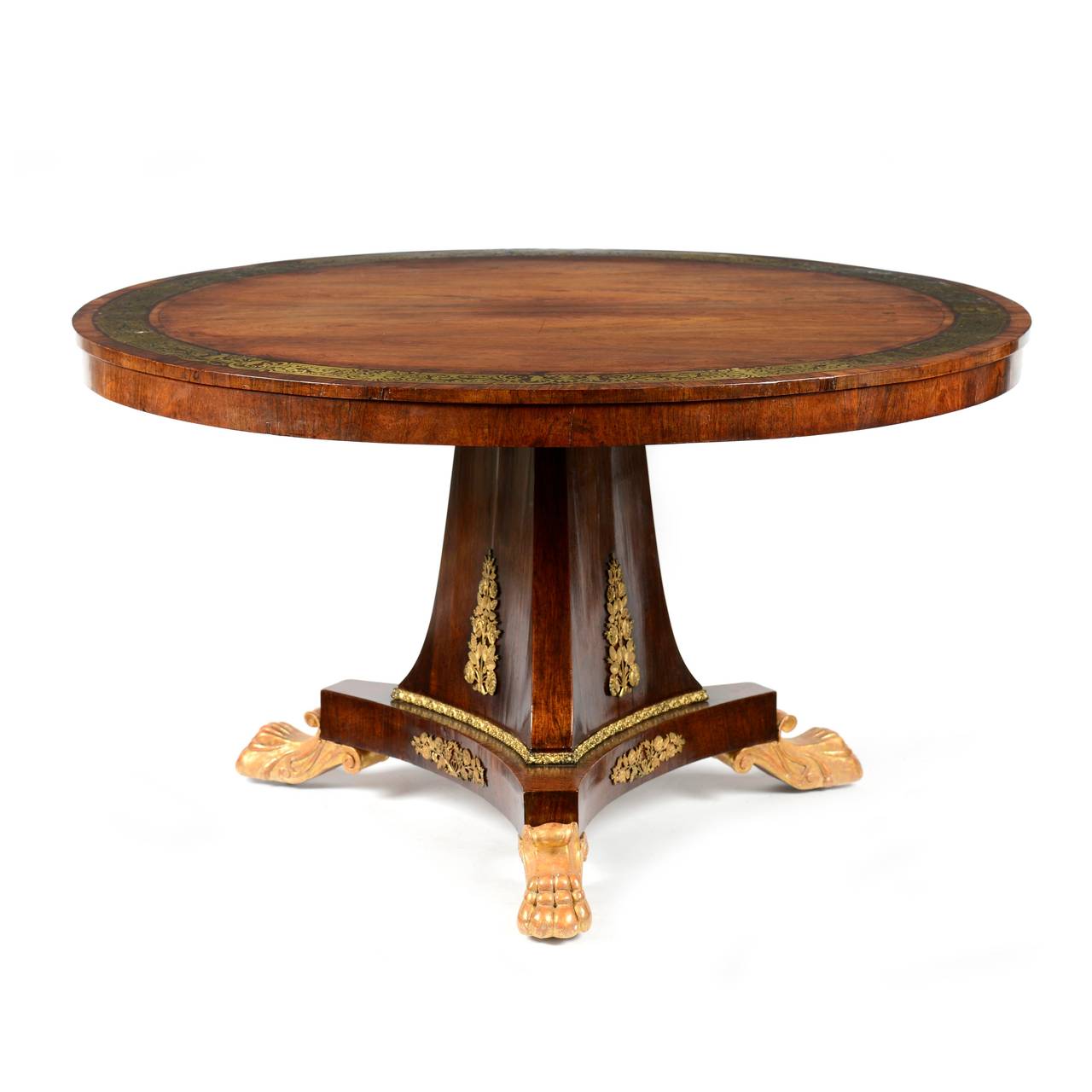 A superb Regency rosewood and brass inlaid centre table by S. Jamar, London. The circular top of well figured rosewood veneer, cross- banded to the outer circumference, this cross-banding further inlaid with a band of kingwood with a foliate cut