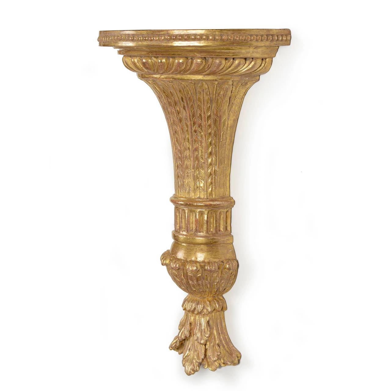 A fine pair of George III carved giltwood wall brackets, of demilune form. The platform top with beaded frieze over a gadrooned neck supported by a leaf carved, curved, tapering central section with double collared fluted ankles, with leaf car and