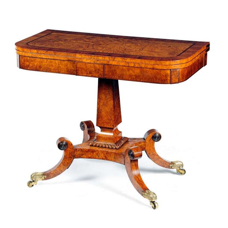 A fine pair of Regency burr pollard oak card tables. The top of rectangular shape with rounded front corners, strung with partridge wood and cross-banded in kingwood. The top swivels and opens to reveal a baize lined playing surface, with