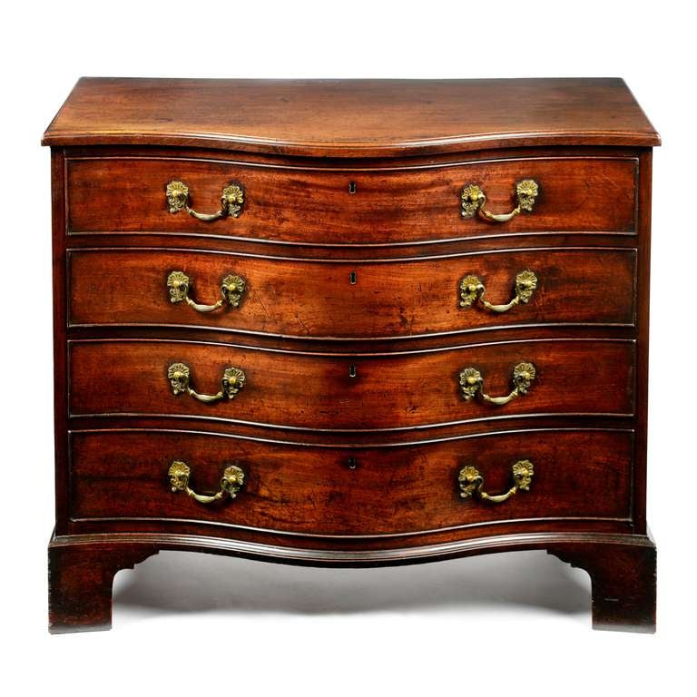 A fine early George III plum pudding Cuban mahogany compact serpentine commode of with excellent dark original color and patina. The well figured top with deep serpentine profile and with applied moulded edge. Below an arrangement of four plum